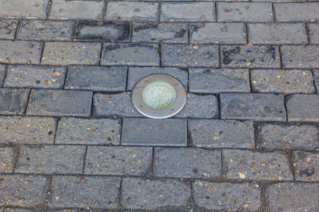 The illumination lamp is mounted in the paving slabs.の写真素材