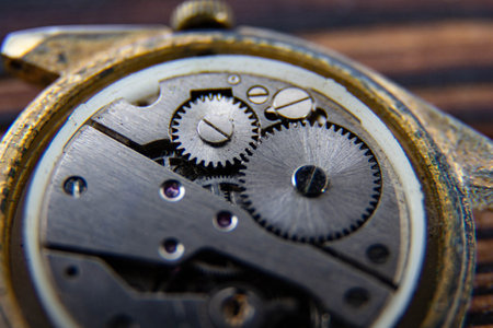 The movement of an old mechanical watch on a wooden background.の写真素材