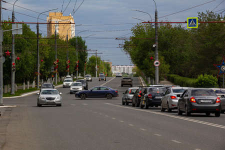 Orenburg, Orenburg region, Russia - 06.13.2021 Cars are parked at the intersection. The inscription on the glass of the car "Yandex taxi"のeditorial素材