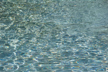 The texture of ripples on the water in a pool with a blue bottomの写真素材