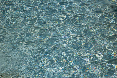 The texture of ripples on the water in a pool with a blue bottomの写真素材