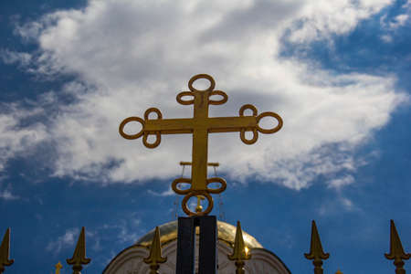 A cross on the roof of an Orthodox church against the sky.の写真素材