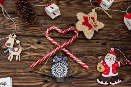 Christmas tree toys and sweets on a wooden background among pine branches.の写真素材