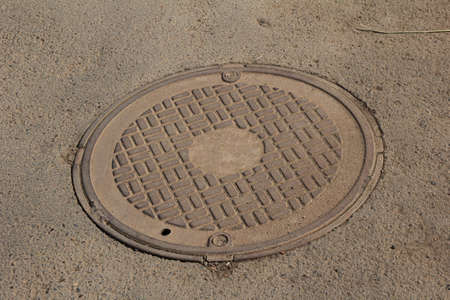 Old cast iron manhole coverの写真素材