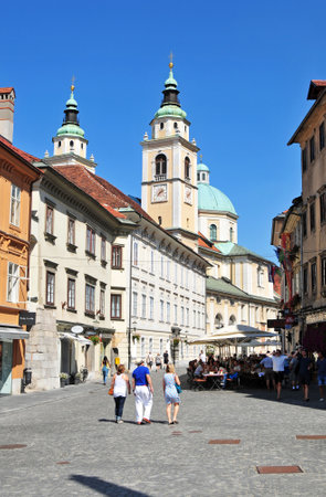 Ljubljana, Slovenia - September 1, 2015 - Street in Ljubljanas old city center and St. Nicholas cathedral in the backgroundのeditorial素材