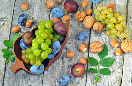 Fresh ripe autumn fruits on a wooden tableの写真素材