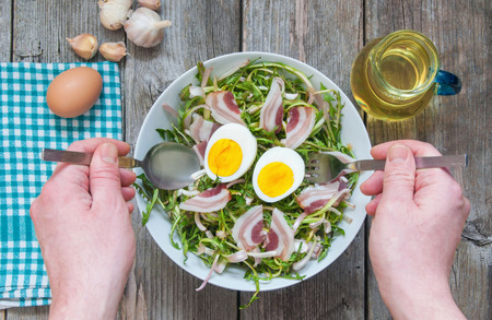 Fresh dandelion salad with boiled eggs and baconの写真素材