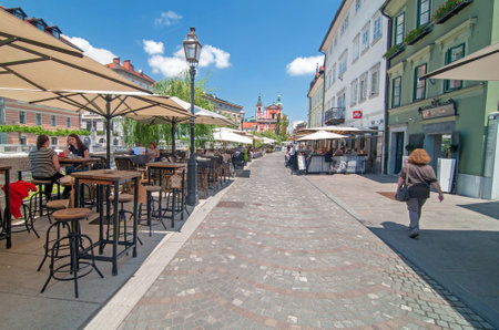 Ljubljana, Slovenia - June 7, 2016 People walking and sitting in cafe bars in Ljubljanas old town center on a bright sunny dayのeditorial素材