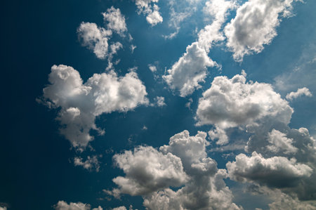 White clouds on a clear blue sky background
