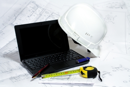 notebook and hardhat on the drawingsの写真素材