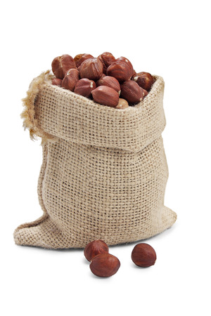 hazelnut in sack on white backgroundの写真素材