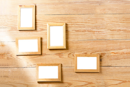 Empty photo frames on a wooden wallの写真素材