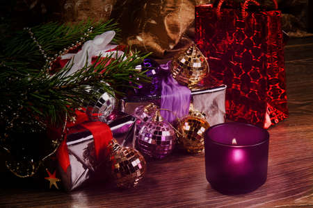 candle with balls and gifts on the floor near the Christmas treeの写真素材