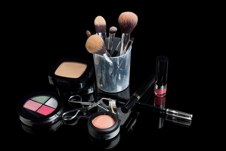make up brush set and make up on black background