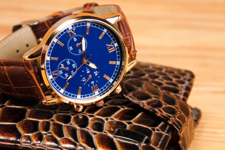 man's watch with clock face and wallet on table. close upの写真素材