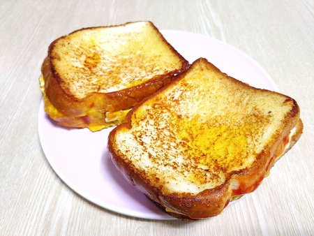 Toasted bread with butter and honey on a plate on the table