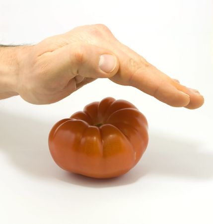 Human hand and tomato isolated on whiteの写真素材