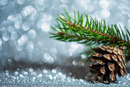 christmas card decoration with cone and defocused silver glitter, snow effect, winter holiday...
