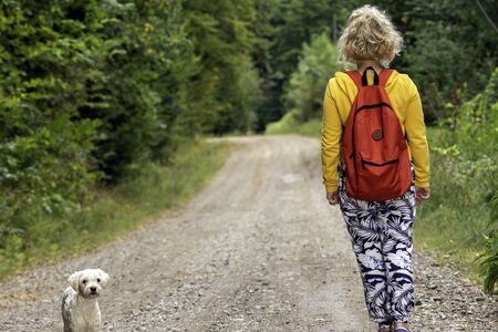 Girl walking with the dog, love animalsの写真素材