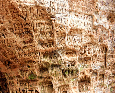 Signs on the wall at Gutmana cave in Turaida, Latvia