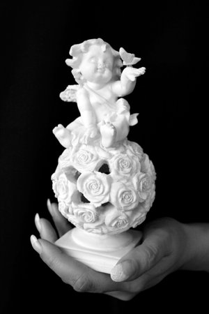 Hand and angel statue with a butterfly