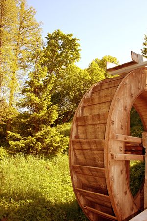 A large water wood wheel generating energy for a corn millの写真素材