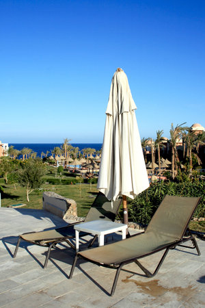 Chairs and parasol wait touristsの写真素材