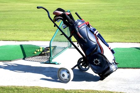 Golf bag and set of clubs on greenの写真素材