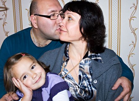 Happy loving couple and smiling daughterの写真素材