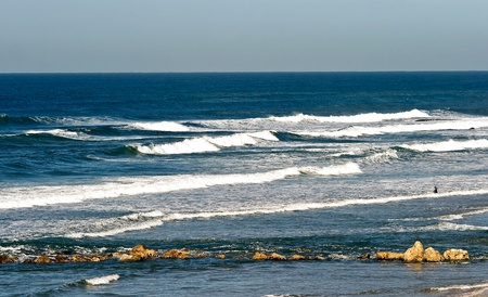 Lonely surfer - among the waves of Mediterranean seaの写真素材