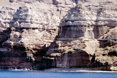 Volcanic rocks of Santorini island ashore Aegean seaの写真素材