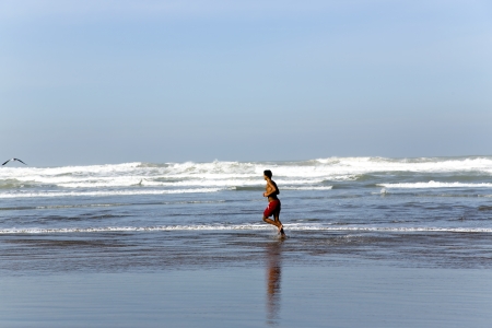 Sporting young man is engaged in run ashore the Atlantic ocean in Casablanca, Moroccoのeditorial素材