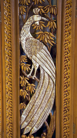 Section of an ancient mural wood carving art from Thailand. The production of things from a teak is very important for a country.の写真素材