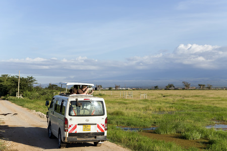 AFRICA, KENYA, MAY, 05, 2016 - Visitors on jeep shoot near Mount Kilimanjaro in Amboseli National Park at Rift Valley Province of Kenya.のeditorial素材