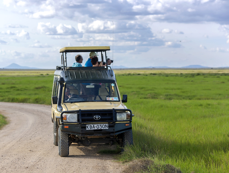 AFRICA, TANZANIA, MAY, 06, 2016 - Visitors on jeep pictures of wild animals in Tarangire National Park, Tanzania.のeditorial素材