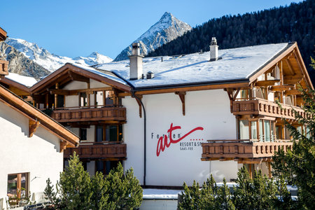SWITZERLAND, SAAS-FEE, DECEMBER, 26, 2015 - Modern wooden Ferienart Resort & Spa hotel on a background mountains in the charming Swiss resort of Saas-Fee, Switzerlandのeditorial素材
