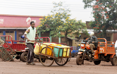 AFRICA, TANZANIA, MAY, 09, 2016 - Typical street scene in Arusha. A series of motobikes are parked in front of the citys local. Arusha is located below Mount Meru in the eastern branch of the Great Rift Valley and the capital of the Arusha Region.のeditorial素材
