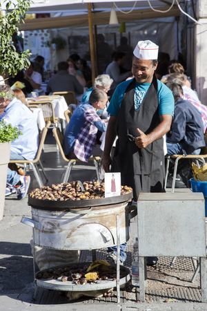 ITALY, VATICAN CITY, OCTOBER, 28, 2014 -Smiling streetseller of roasted chestnuts on the streets in Vatican, Italy.のeditorial素材