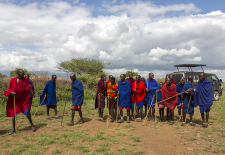 AFRICA, KENYA, MAY, 5, 2016 - Group men Maasai tribe dressed in bright red blankets and ornaments from beads posing for tourists in Kenya, Africaのeditorial素材