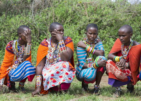 AFRICA, KENYA, MAY, 5, 2016 - Group women of Maasai tribe dressed in bright red blankets and ornaments from beads posing for tourists in Kenya, Africaのeditorial素材