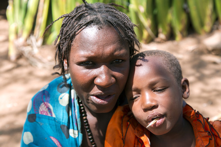 AFRICA, TANZANIA, MAY, 10, 2016 - Portrait woman with a child close-up of the Hadzabe tribe. Hadzabe tribe threatened by extinction in Tanzania, Africaのeditorial素材