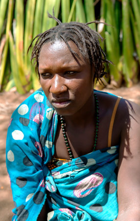 AFRICA, TANZANIA, MAY, 10, 2016 - Portrait typical woman with bead decoration and african pigtails...