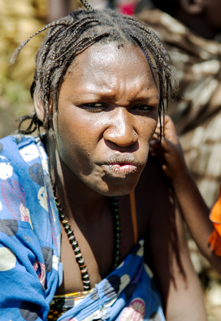 AFRICA, TANZANIA, MAY, 10, 2016 - Portrait typical woman with bead decoration and african pigtails of the Hadzabe tribe. Hadzabe tribe threatened by extinction in Tanzania, Africaのeditorial素材