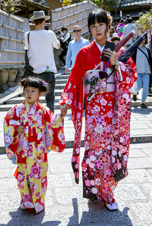 JAPAN, KYOTO, APRIL, 05, 2017 - A young Japanese mother with a little daughter in bright multicolored kimono of Gion district, Kyoto Japan.のeditorial素材
