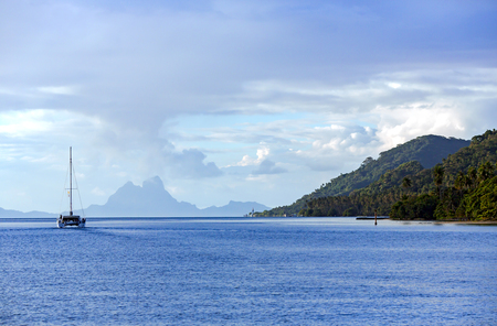 Lonely catamaran heading for the French Island of the Polynesia.の写真素材