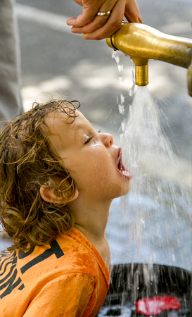 SPAIN, BARCELONA, MAY, 2018 - Small child enjoys drinking waterのeditorial素材