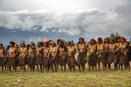 INDONESIA, PAPUA NEW GUINEA, WAMENA, IRIAN JAYA, AUGUST 20, 2018: Papuans womans of local tribes gathered on Baliem Valley festival in Wamena, Papua New Guinea. The festival usually attended by hundreds of peoples local tribes, all of them come with theirのeditorial素材