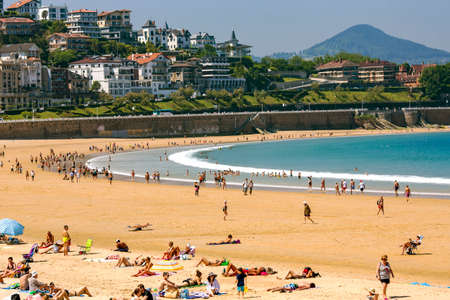 SPAIN, SAN SEBASTIAN, MAY, 10, 2018 - People enjoying playa de La Concha beach after the low tide of the Atlantic Ocean, San Sebastian, Donostia, Spainのeditorial素材