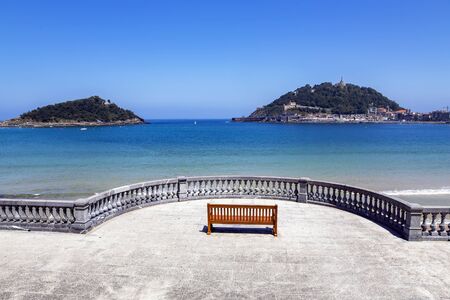 Boardwalk near La Concha beach overlooking Monte Igueldo and Santa Clara Island of the Bay of Biscay, San Sebastian, Donostia, Spainの写真素材