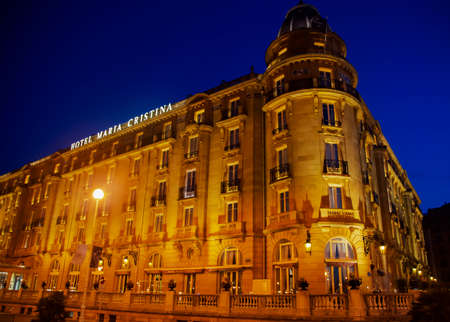 SPAIN, SAN SEBASTIAN, DONOSTIA, MAY, 12, 2017 - Gran Hotel Maria Cristina a Luxury Collection Hotel in night illumination in San Sebastian, Gipuzkoa, Basque Country, Spain.のeditorial素材